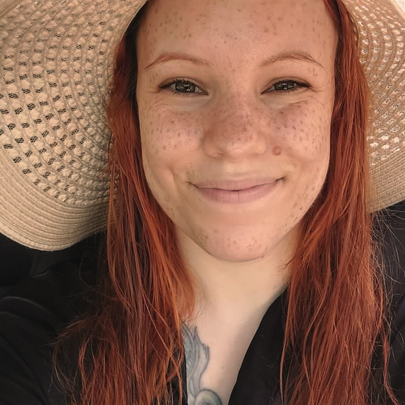 Man sieht eine Nahaufnahme von einem Frauengesicht von Sommersprossen Tattoos.